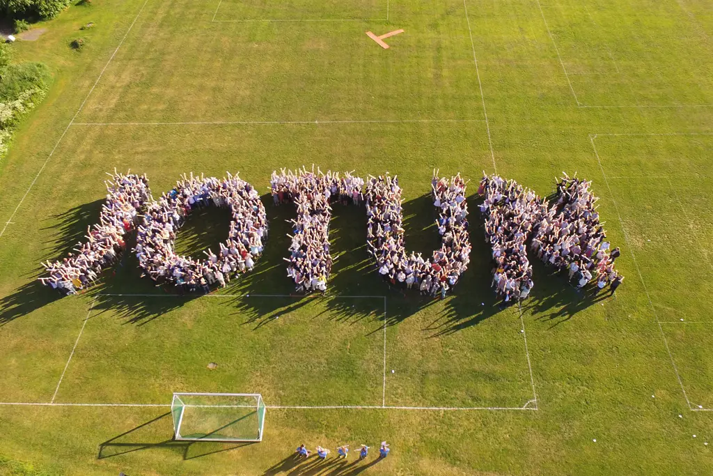 Happy people forming the word JOTUN