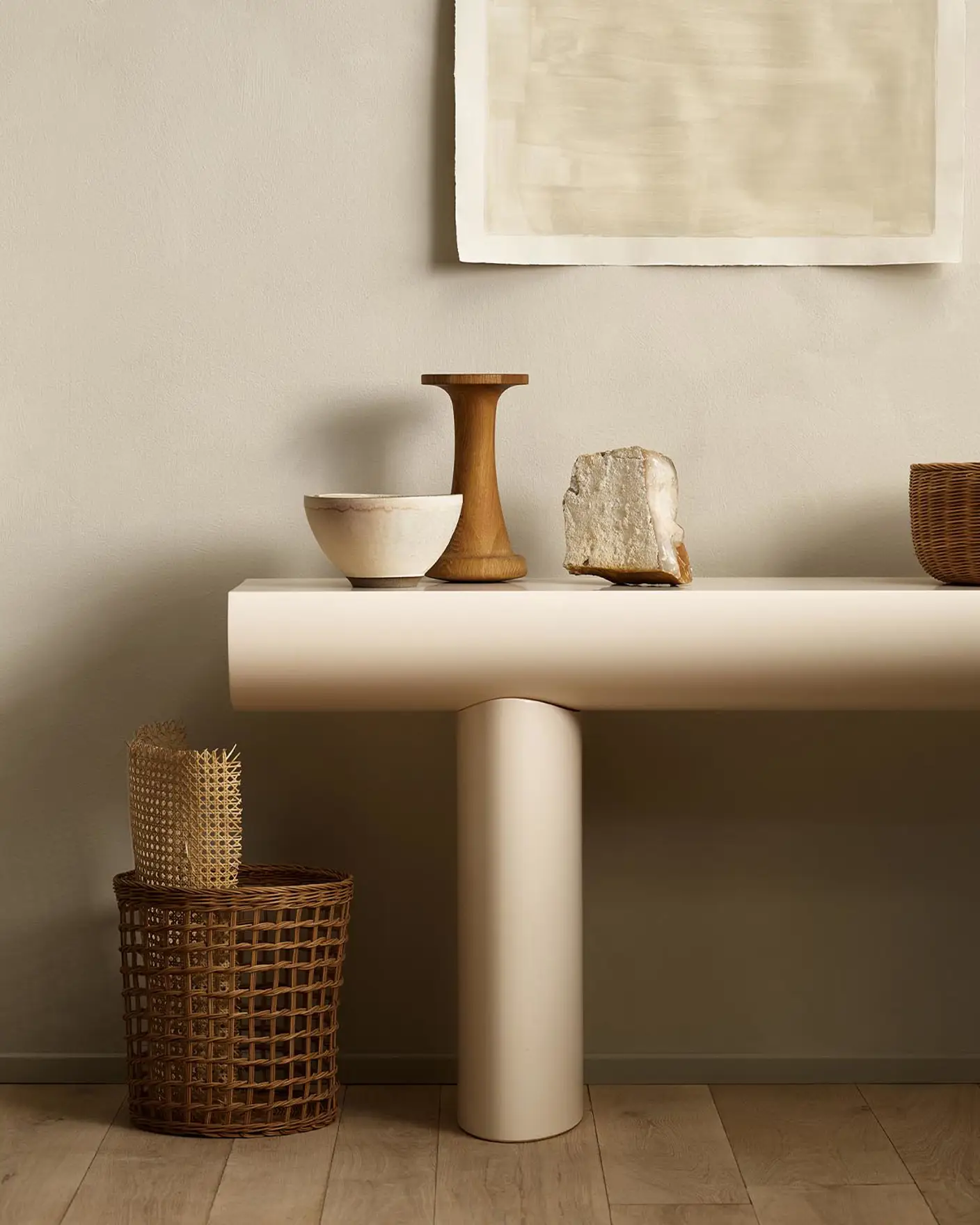 Minimalist console table with decor and baskets against a golden beige wall painted with Jotun's colour 12308 Unbleached.