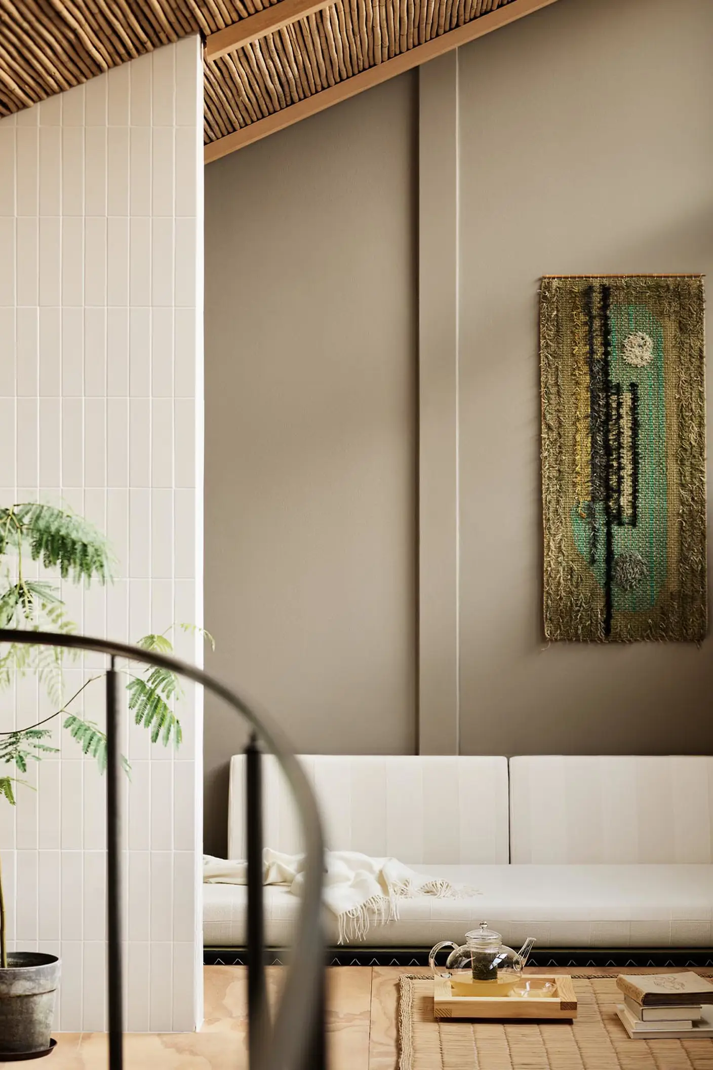 Modern living room with white sofa and abstract wall painting hanging on a golden beige wall painted in the colour 12292 Caramel Brown from Jotun.