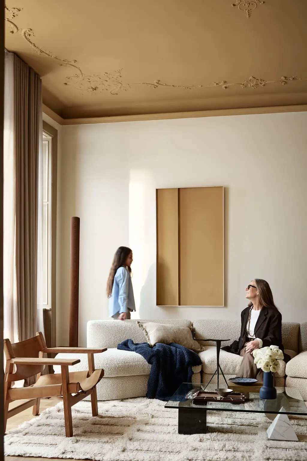 En stue med vægge malet i den lyse beige farve Jotun 1281 Perlebeige, et okkergult loft i Jotun 1909 Kalkoker og detaljer i gyldenbrun Jotun 1799 Spice Brown.