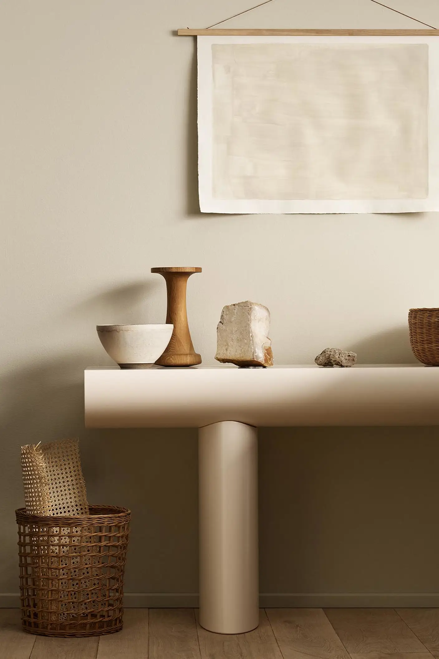 Minimalist console table with decor and baskets against a golden beige wall painted with Jotun's colour 12308 Unbleached.