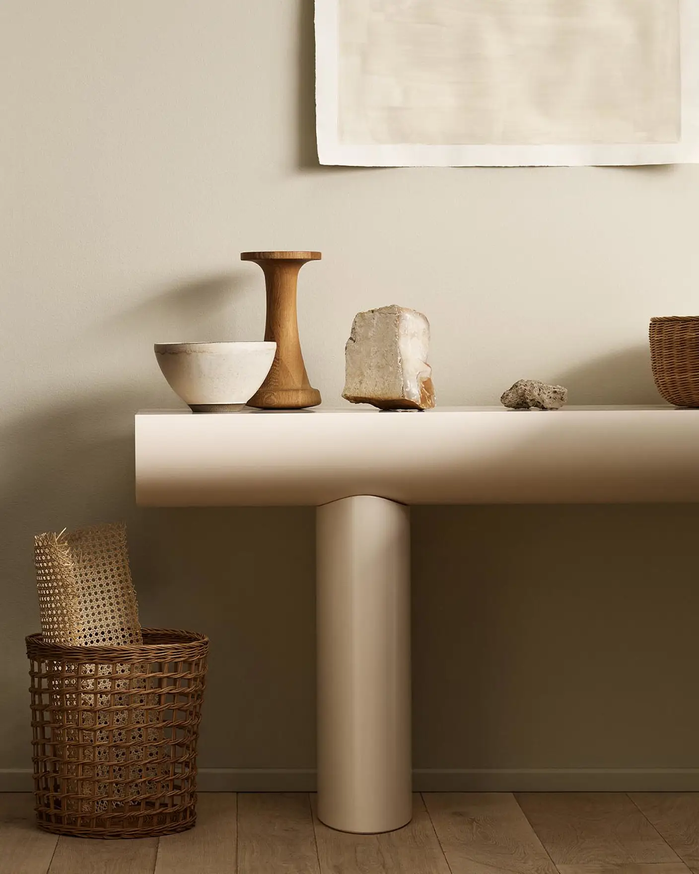 Minimalist console table with decor and baskets against a golden beige wall painted with Jotun's colour 12308 Unbleached.