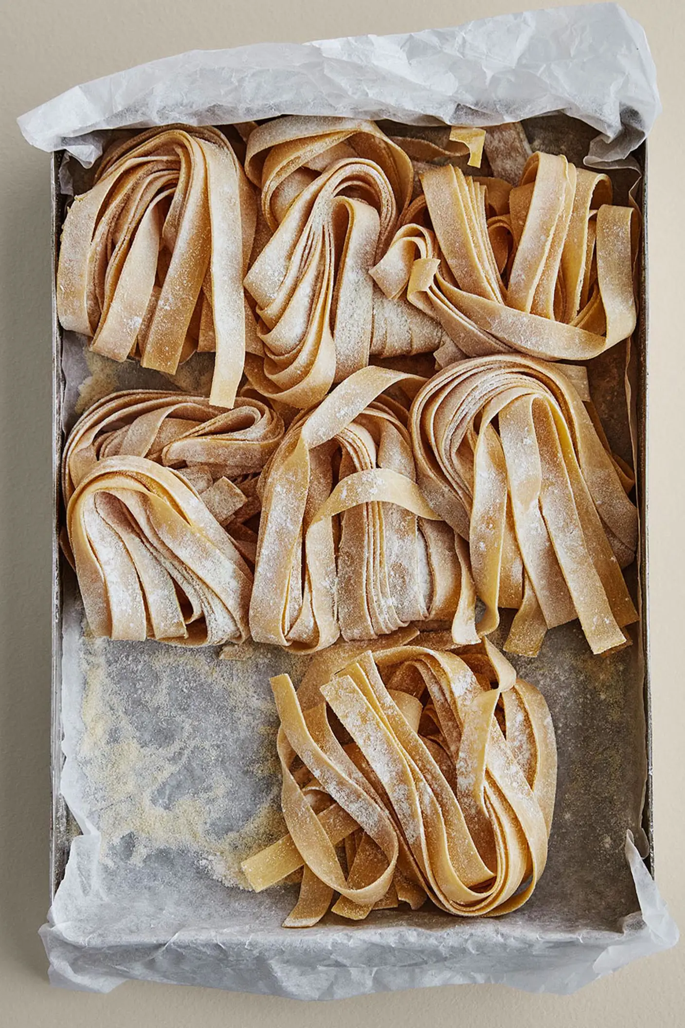 Färsk pasta i en form på en varm beige bakgrund målad med Jotuns färg 10678 Space.