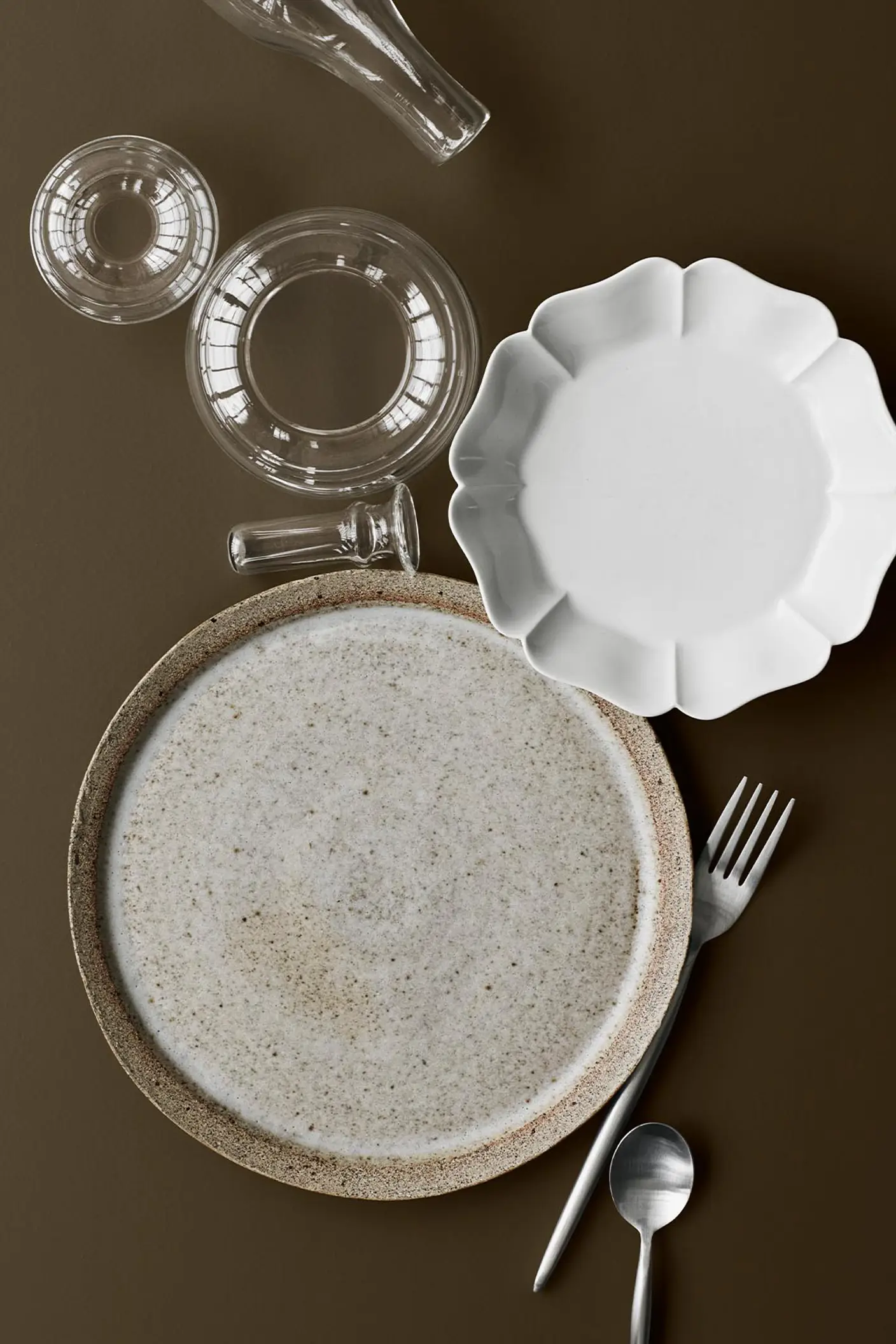 Service i keramik og glas på en gyldenbrun baggrund malet med 10385 Belgian Brown fra Jotun.