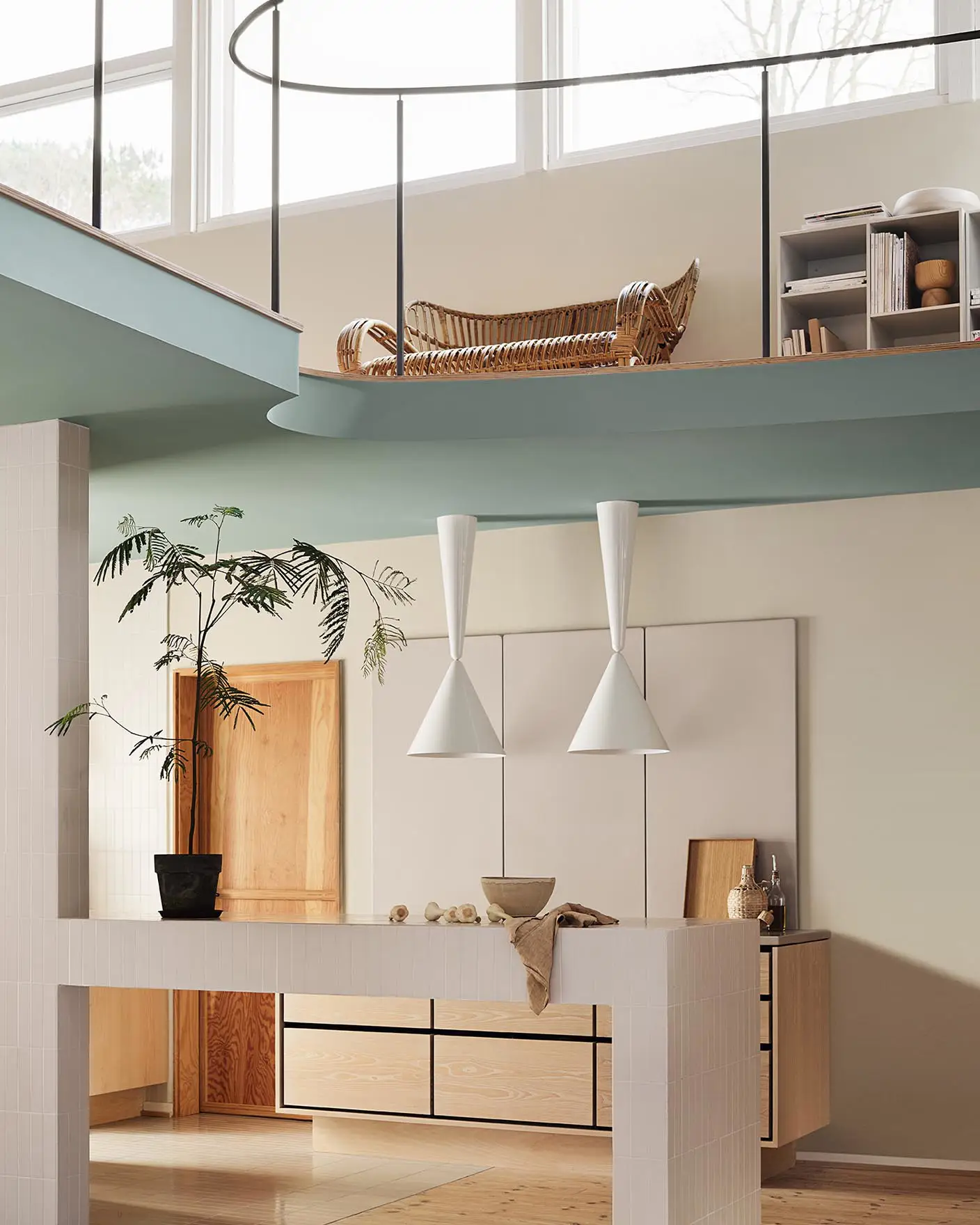 Modern interior with pendant lights and a loft area. Beige walls painted with the Jotun colour 12308 Unbleached. Loft area painted in the bluish green colour 6378 Iconic.