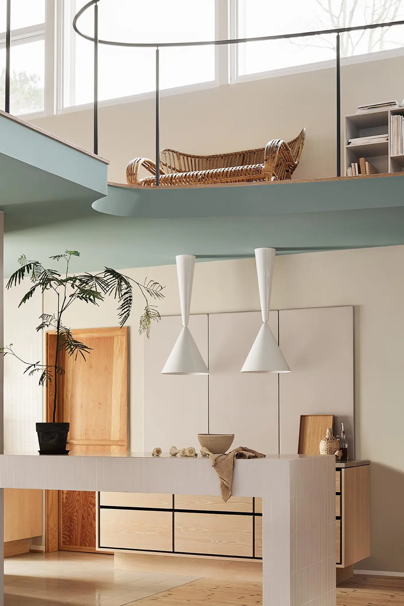Modern interior with pendant lights and a loft area. Beige walls painted with the Jotun colour 12308 Unbleached. Loft area painted in the bluish green colour 6378 Iconic.