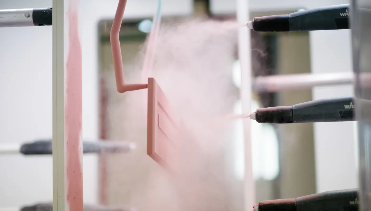 Pink powder coating being applied to a furniture – Jotun