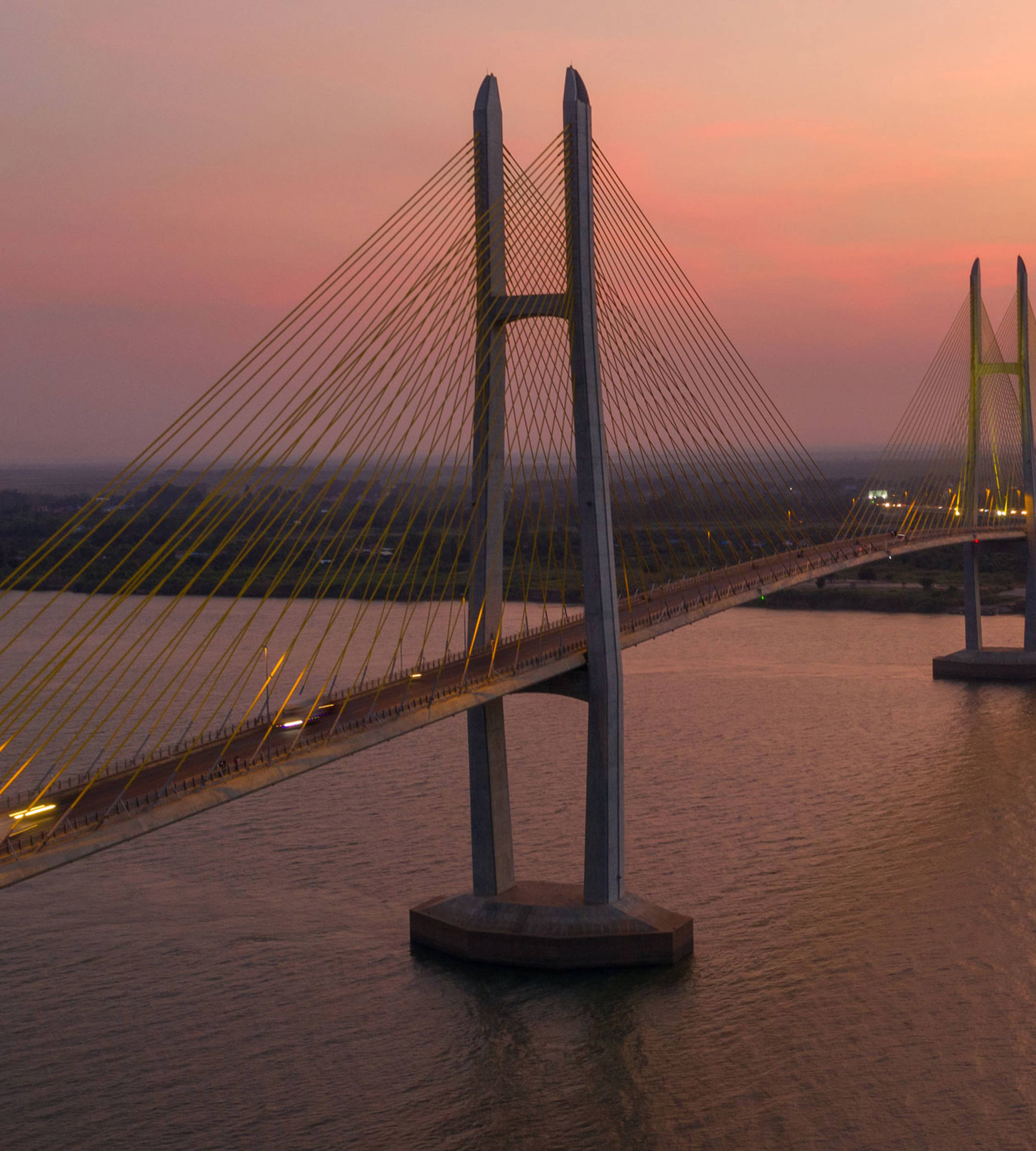 Long suspension bridge below the evening sky