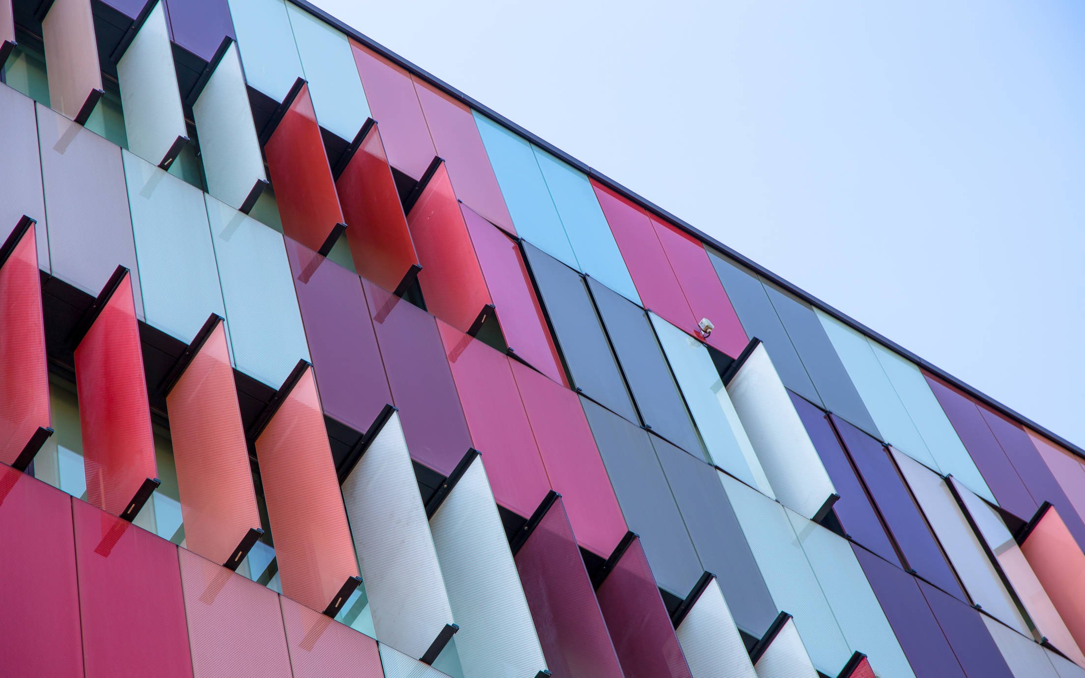 Building covered in red, pink, blue and purple coloured elements