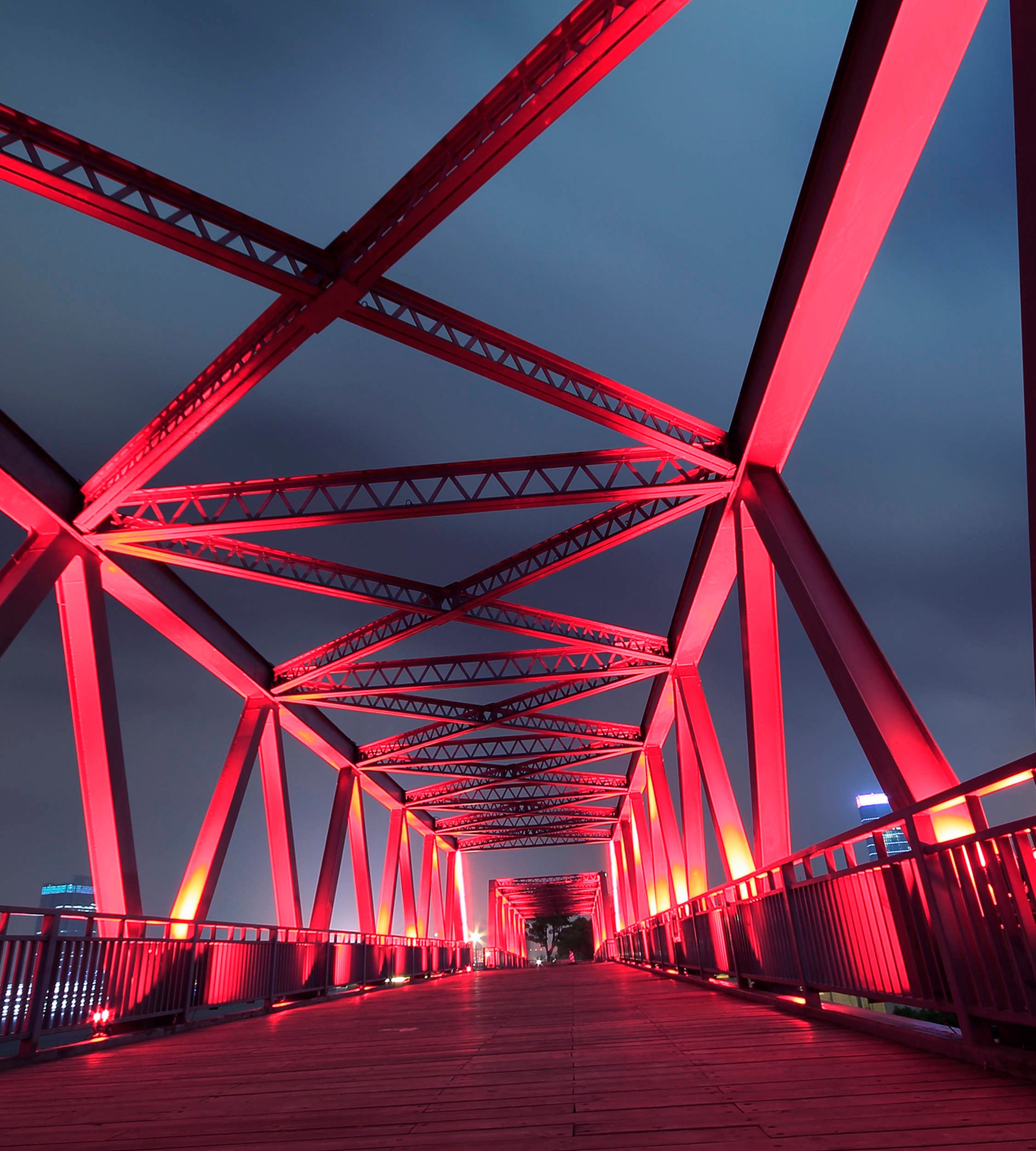 Steel bridge lightened up by red light in the night time