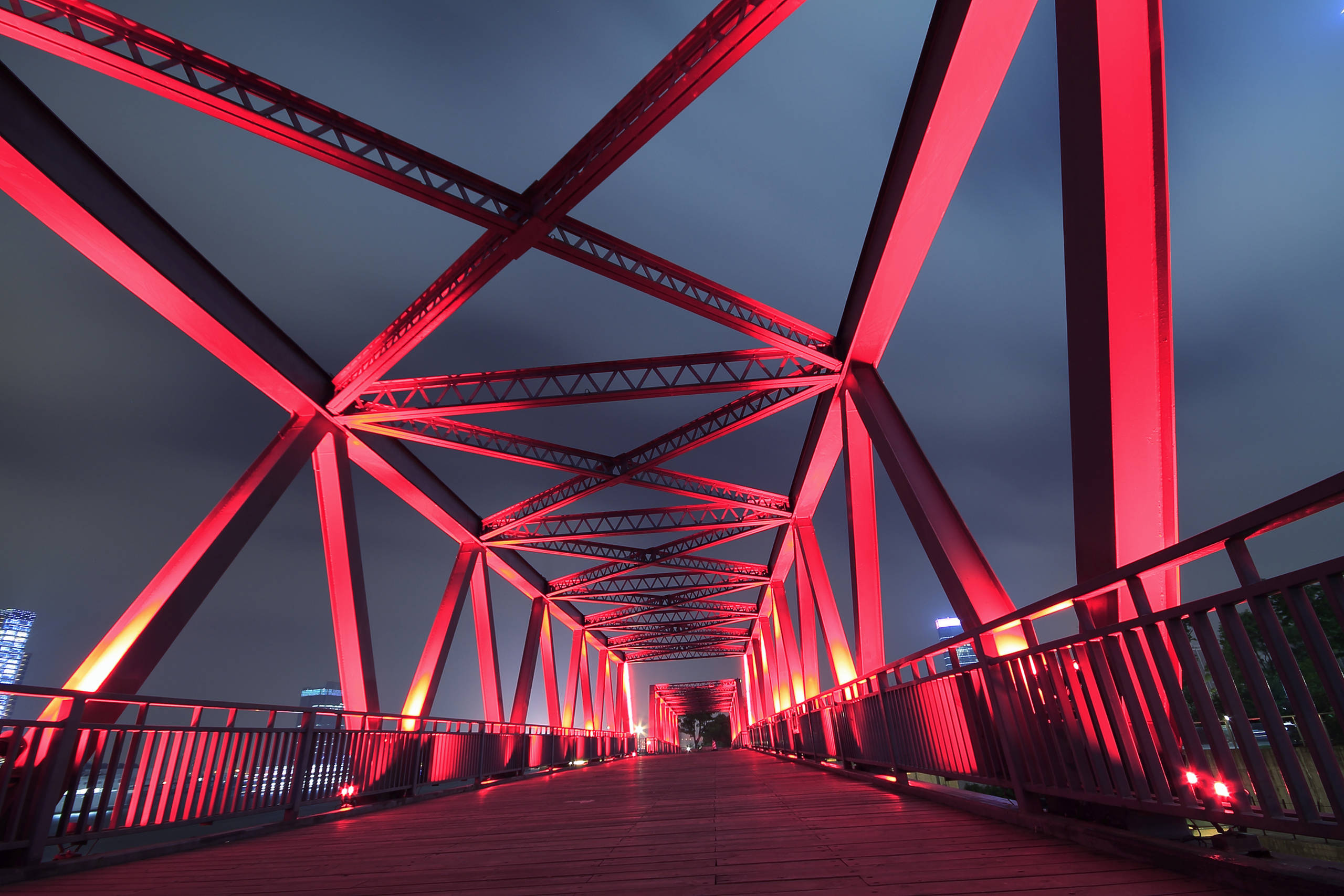 Steel bridge lightened up by red light in the night time