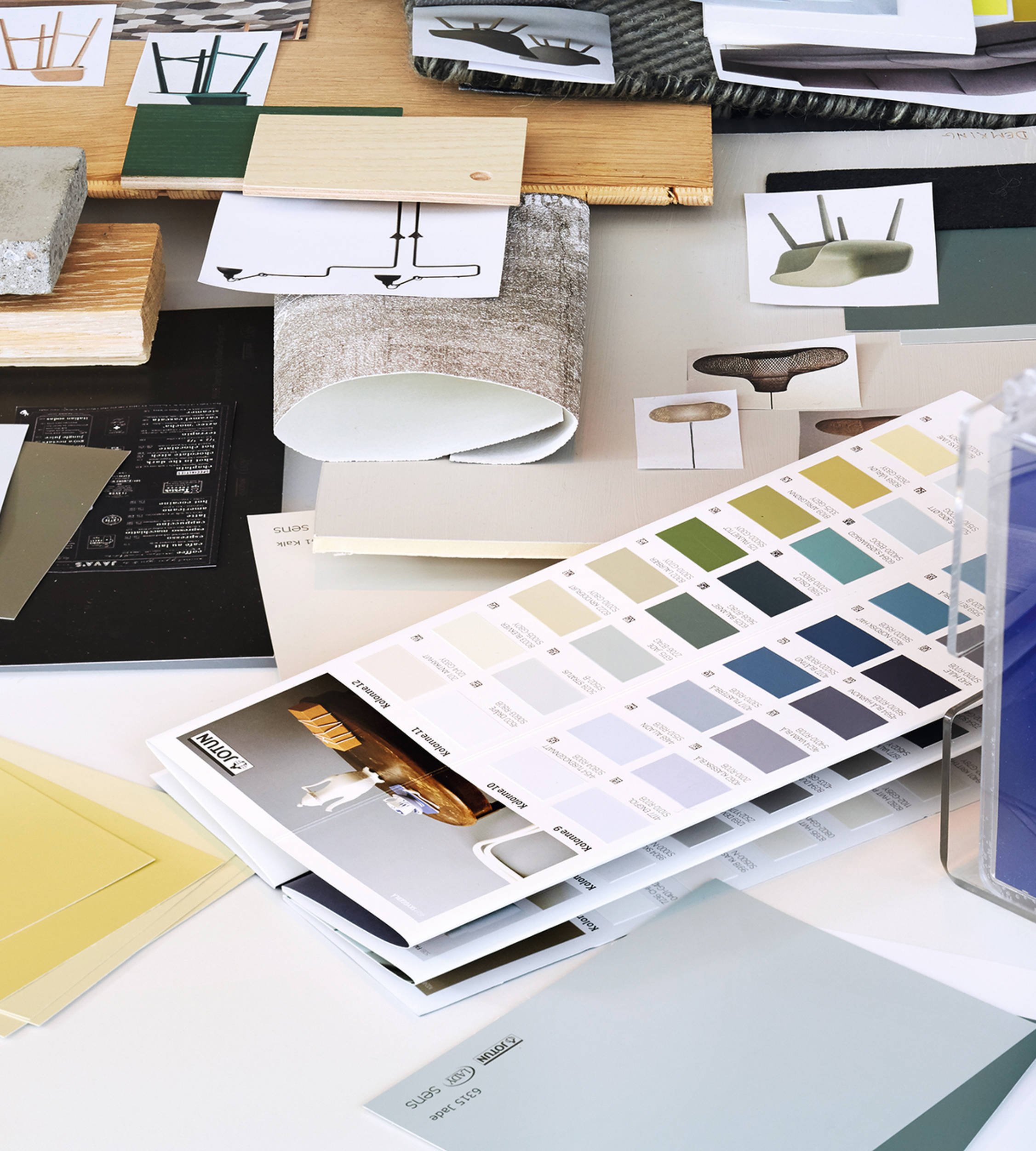 A desk covered with Jotun colour samples