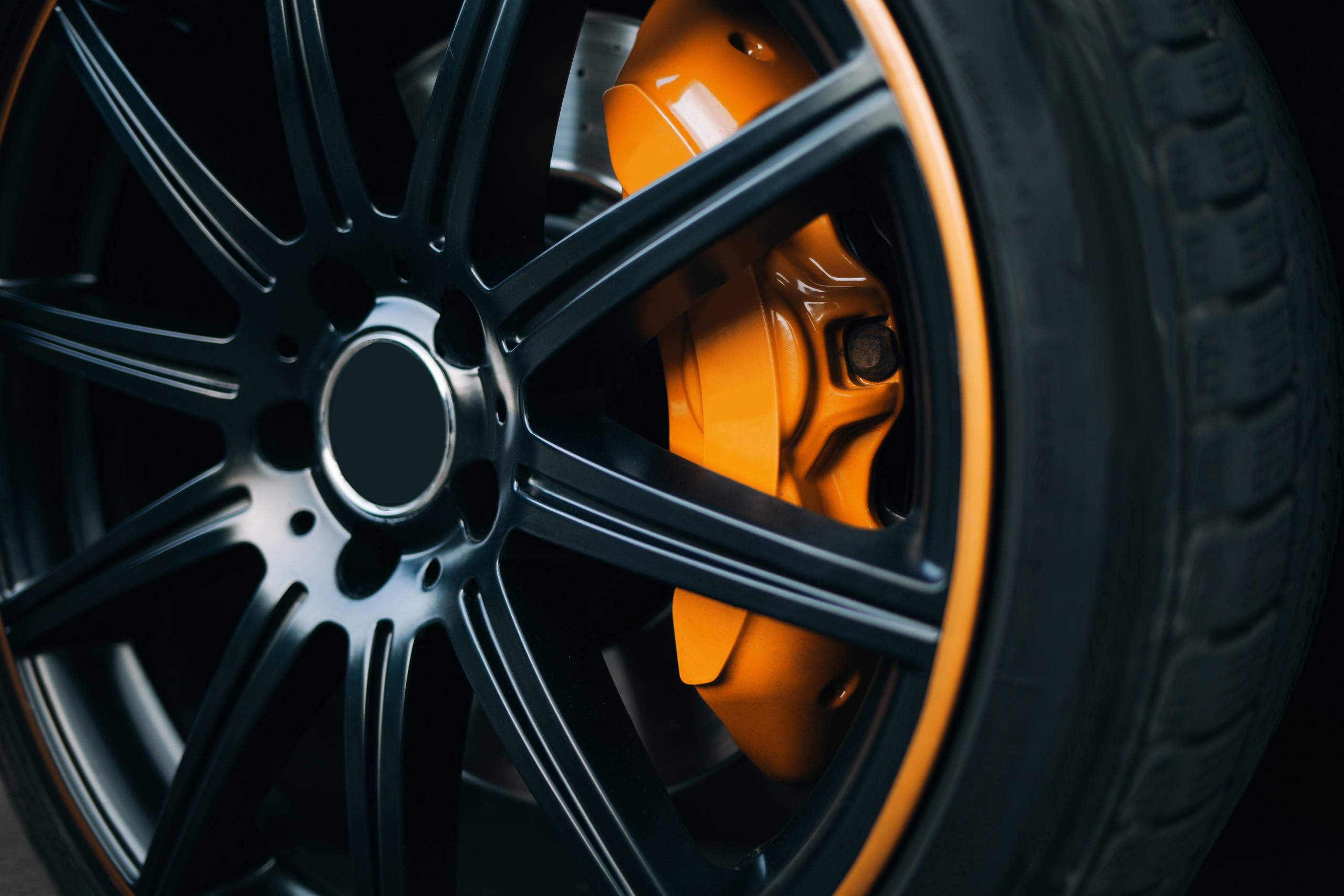 Automotive yellow and black coated wheel close up