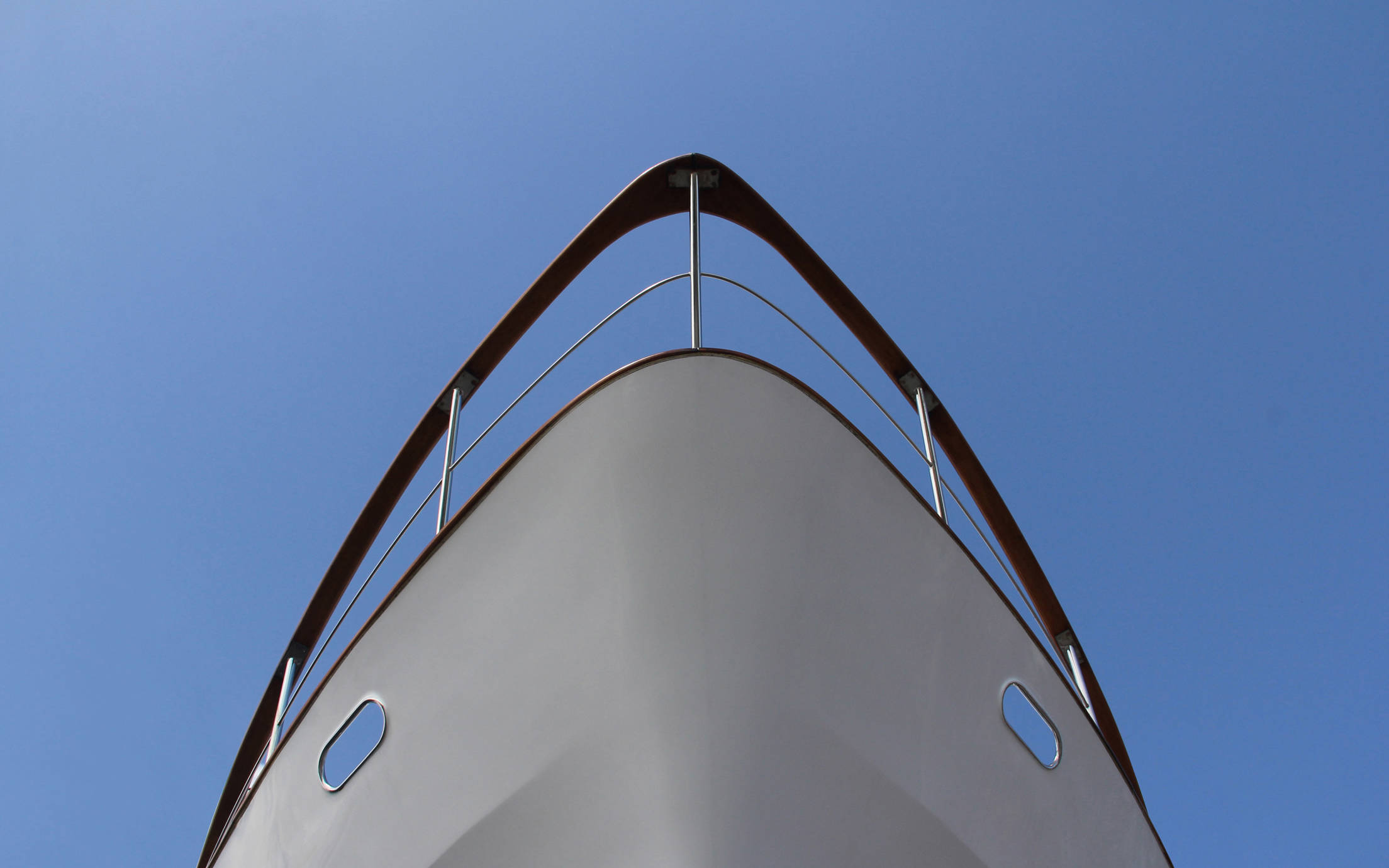 Ships prow seem from below against blue sky