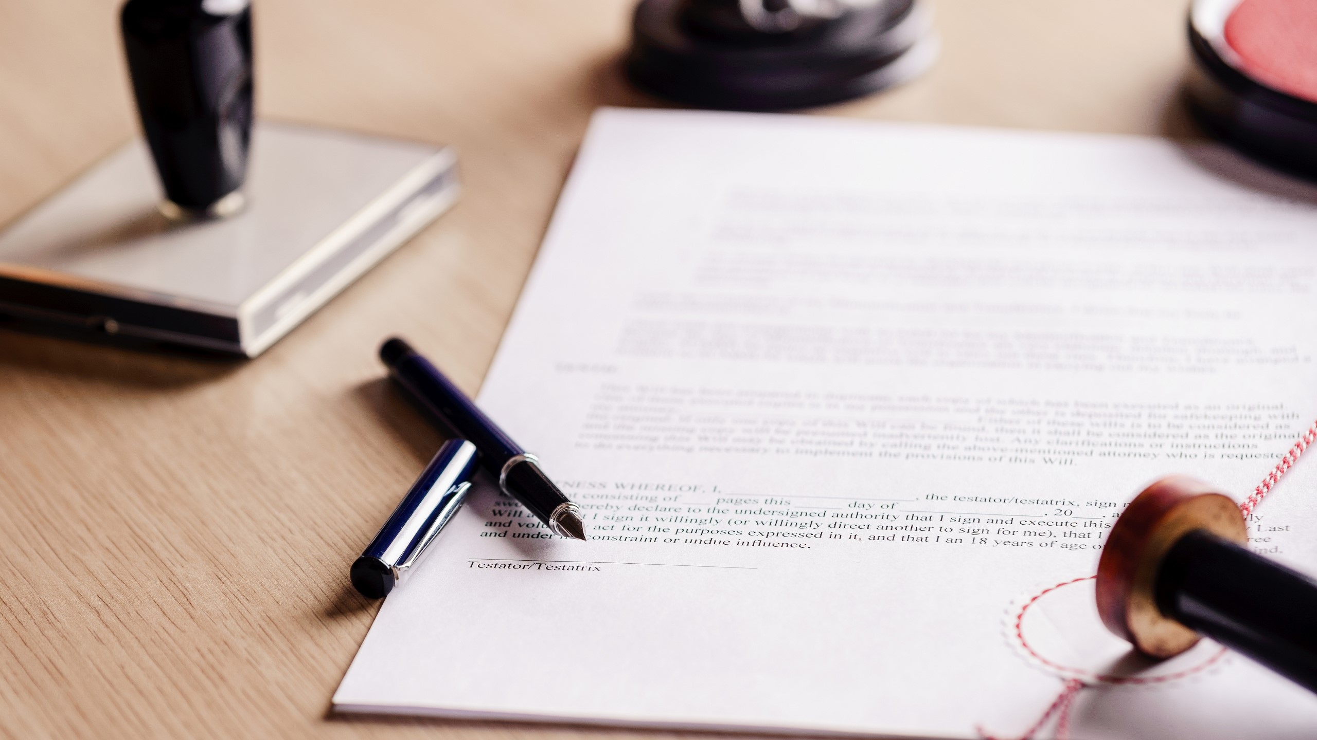 Photo of signed documents and pen laying next to it