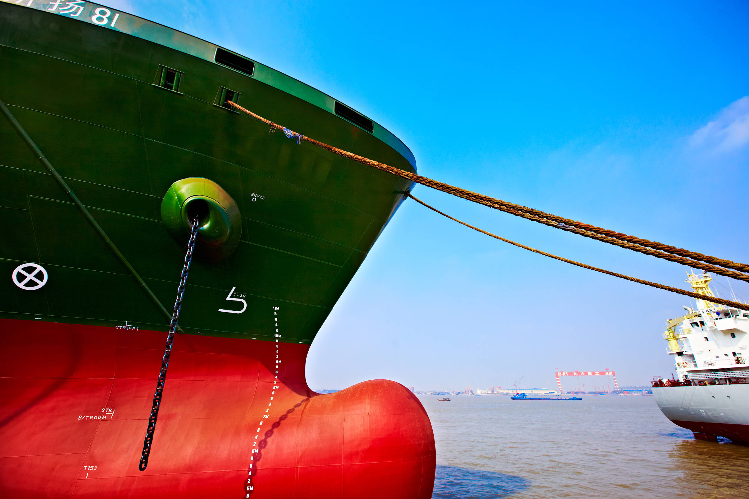 red and black ship hull in harbour