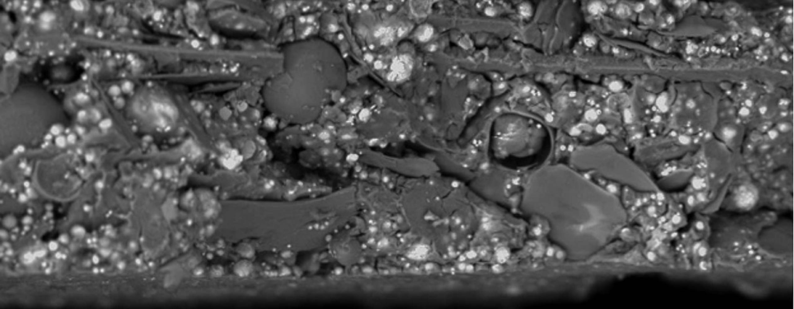 SEM image of an IOZ coating where glass flakes and ceramic spheres have been added to the coating.