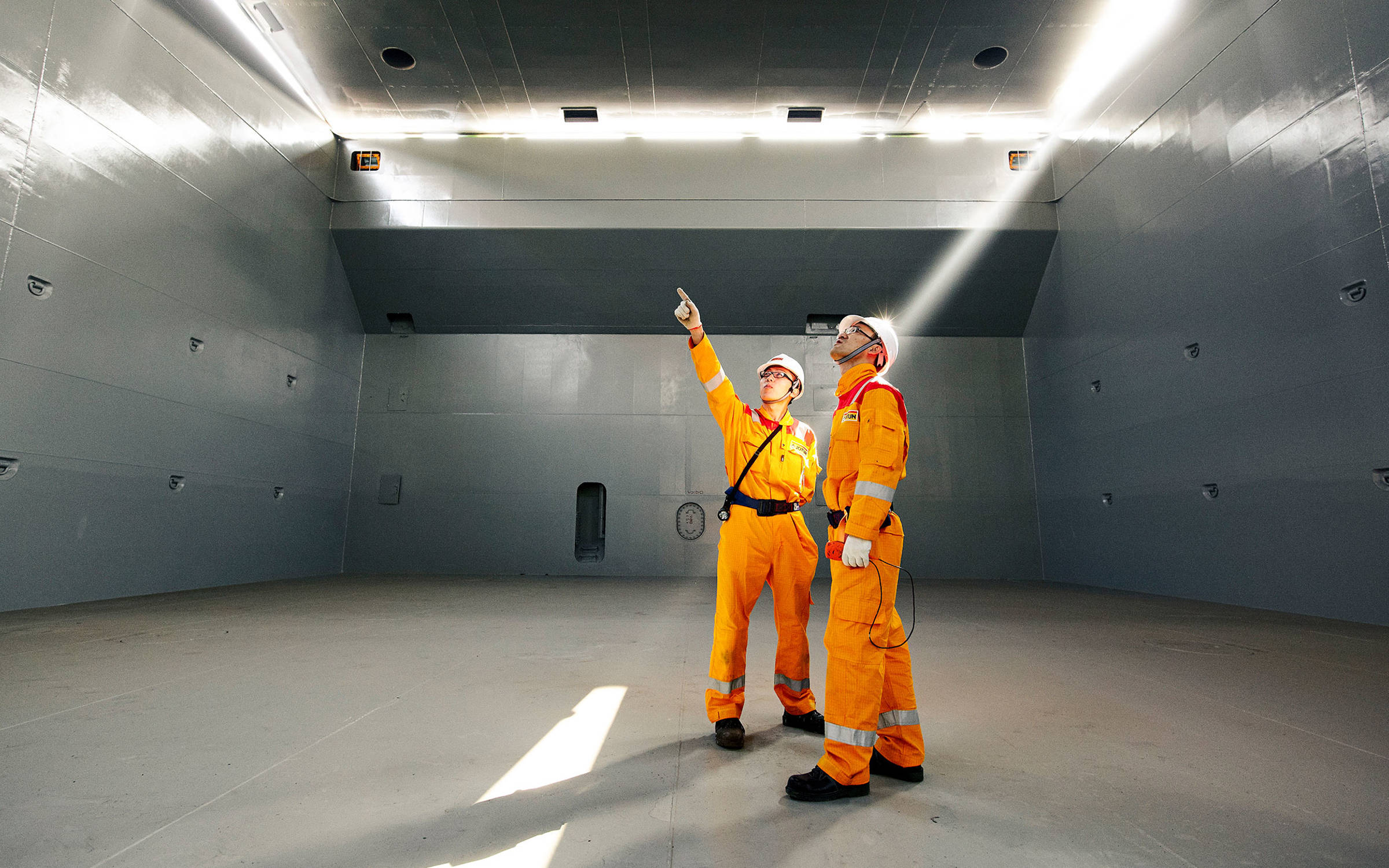 Two members of Jotun's Technical Service team inside a ship hull