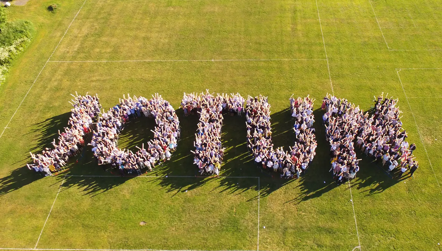 Many Jotun employees standing together outside in a formation that spell Jotun