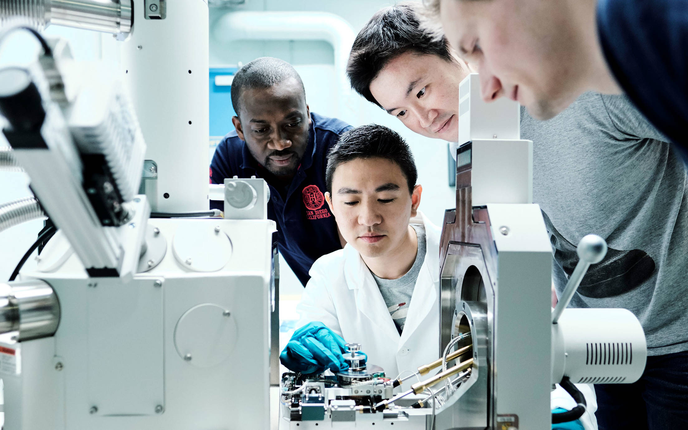 Looking into an advanced microscope at Jotun's Research and Development centre in Sandefjord, Norway