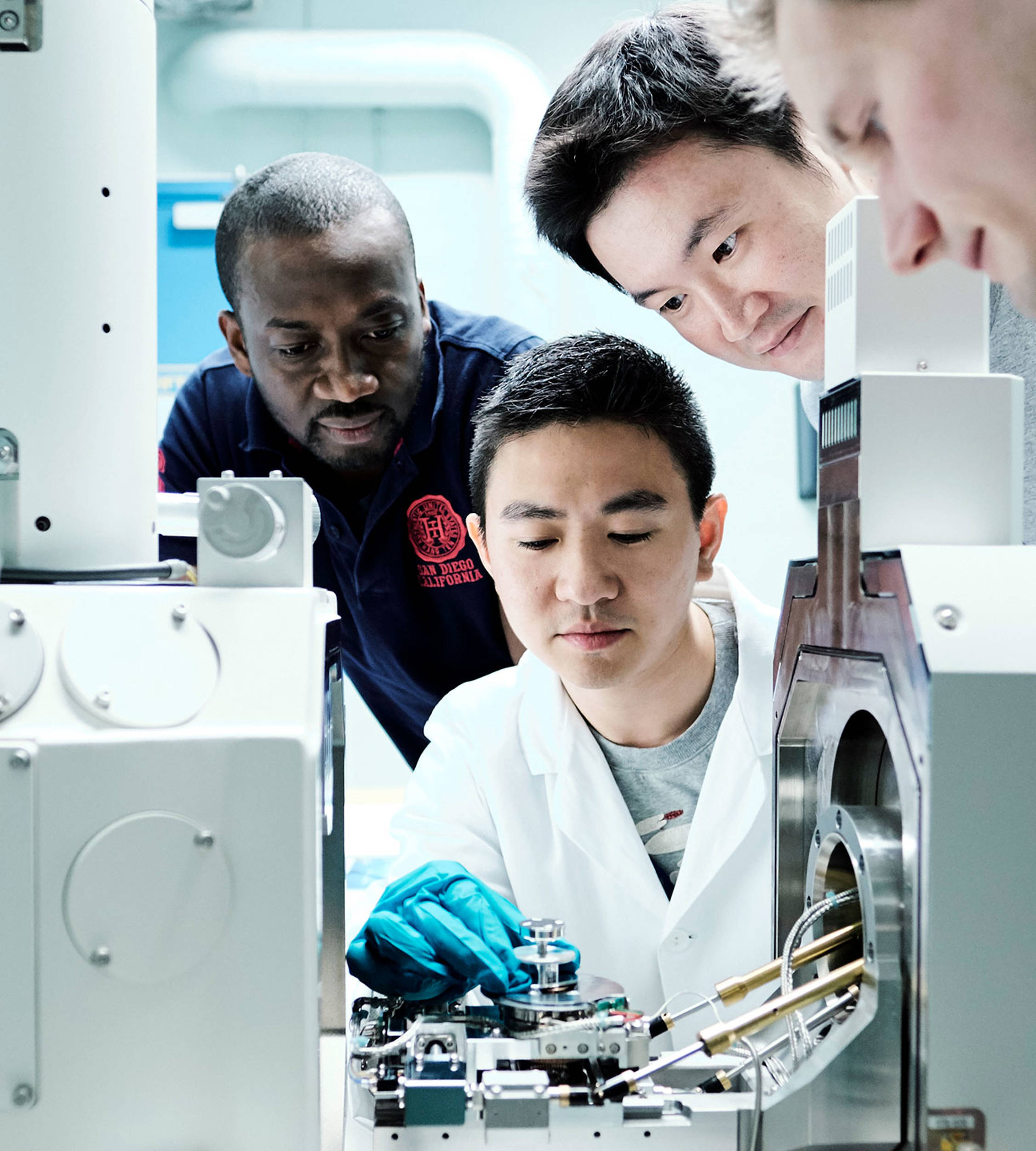 Looking into an advanced microscope at Jotun's Research and Development centre in Sandefjord, Norway