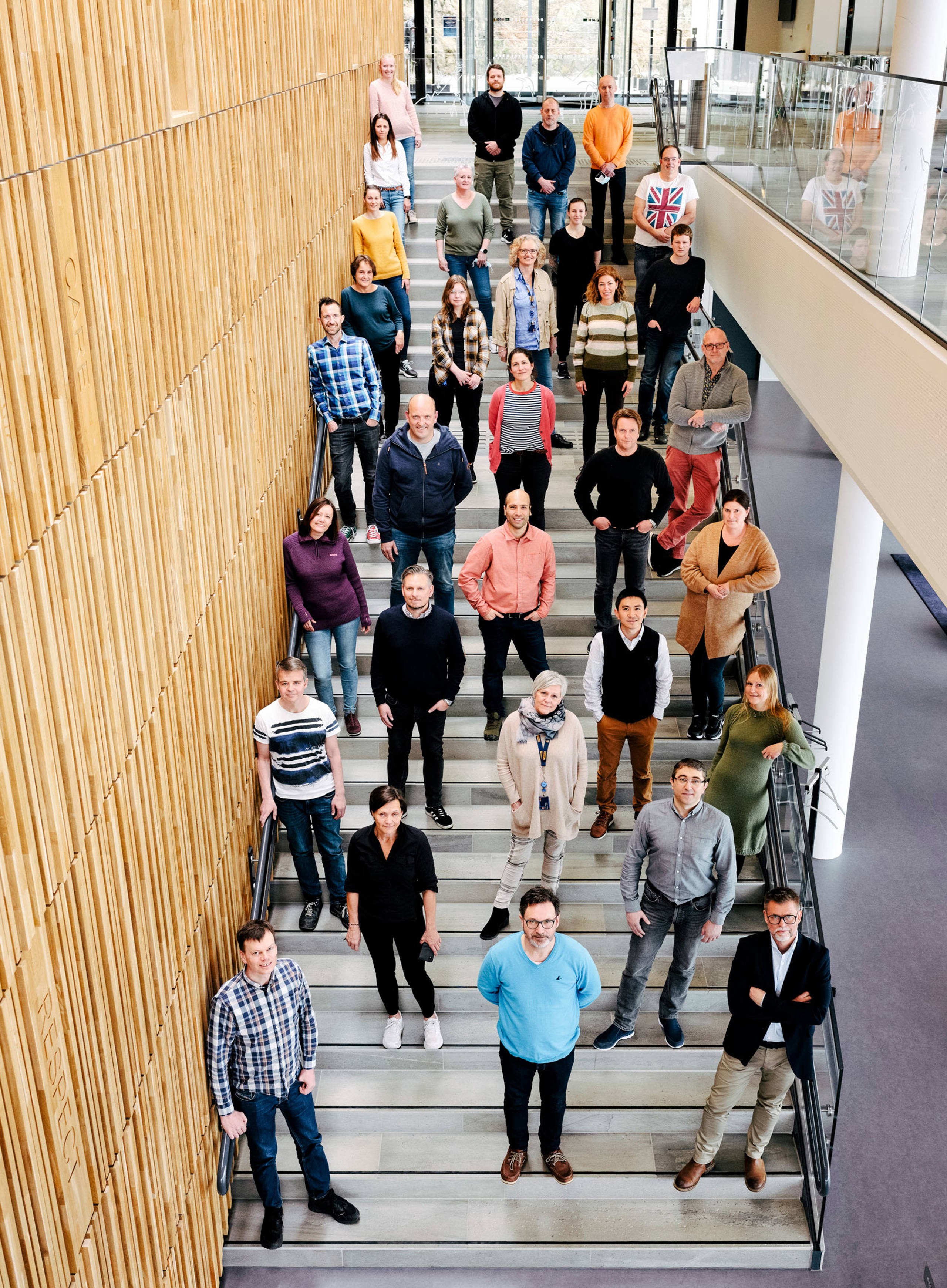Employees photographed in the main stairway in Jotun's HQ in Nrway
