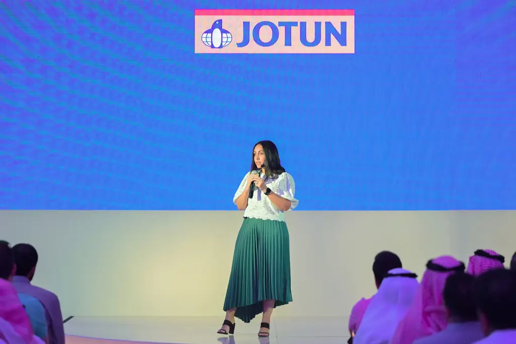 Yasmine Eladly on stage with a microphone