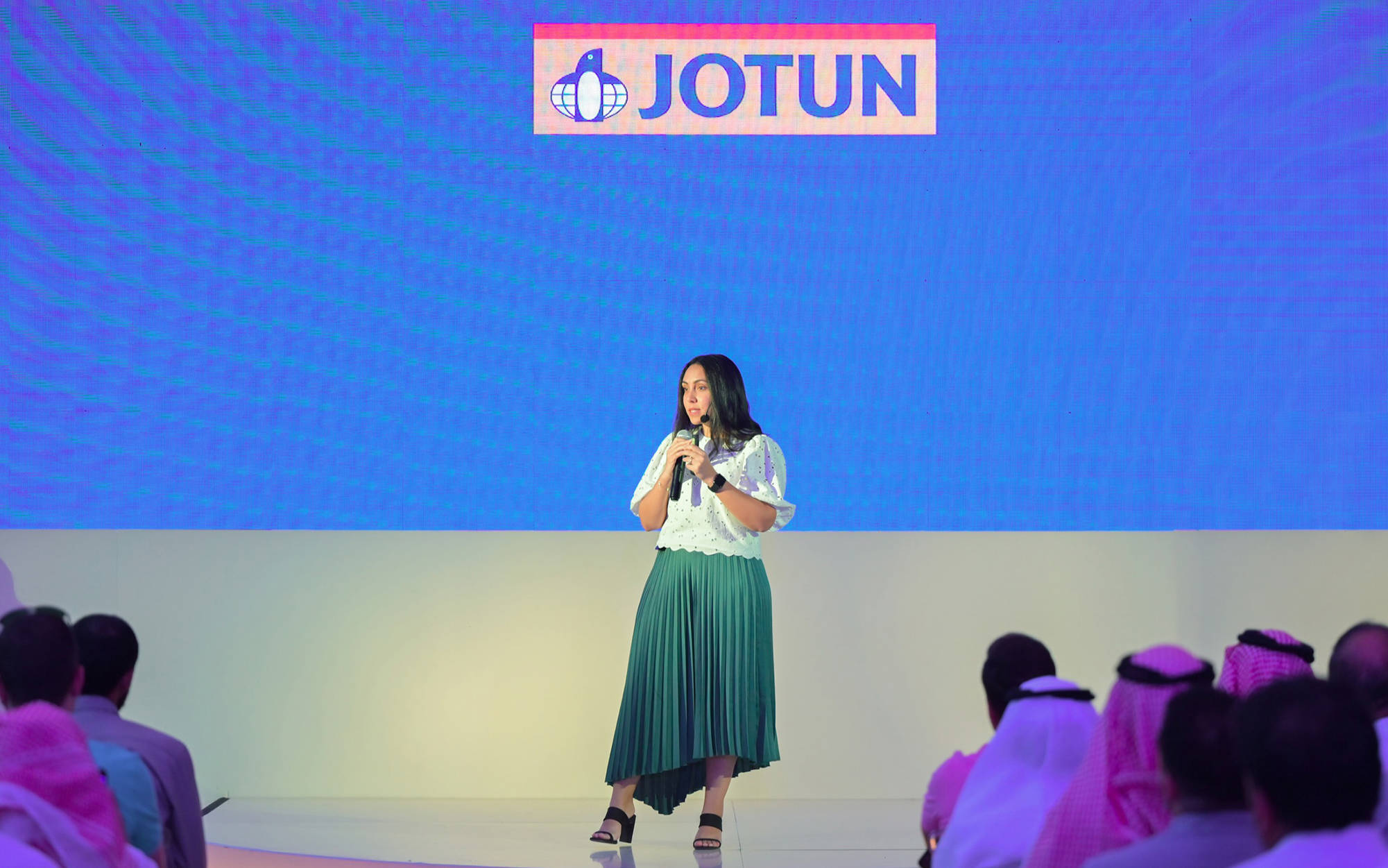 Yasmine Eladly on stage with a microphone