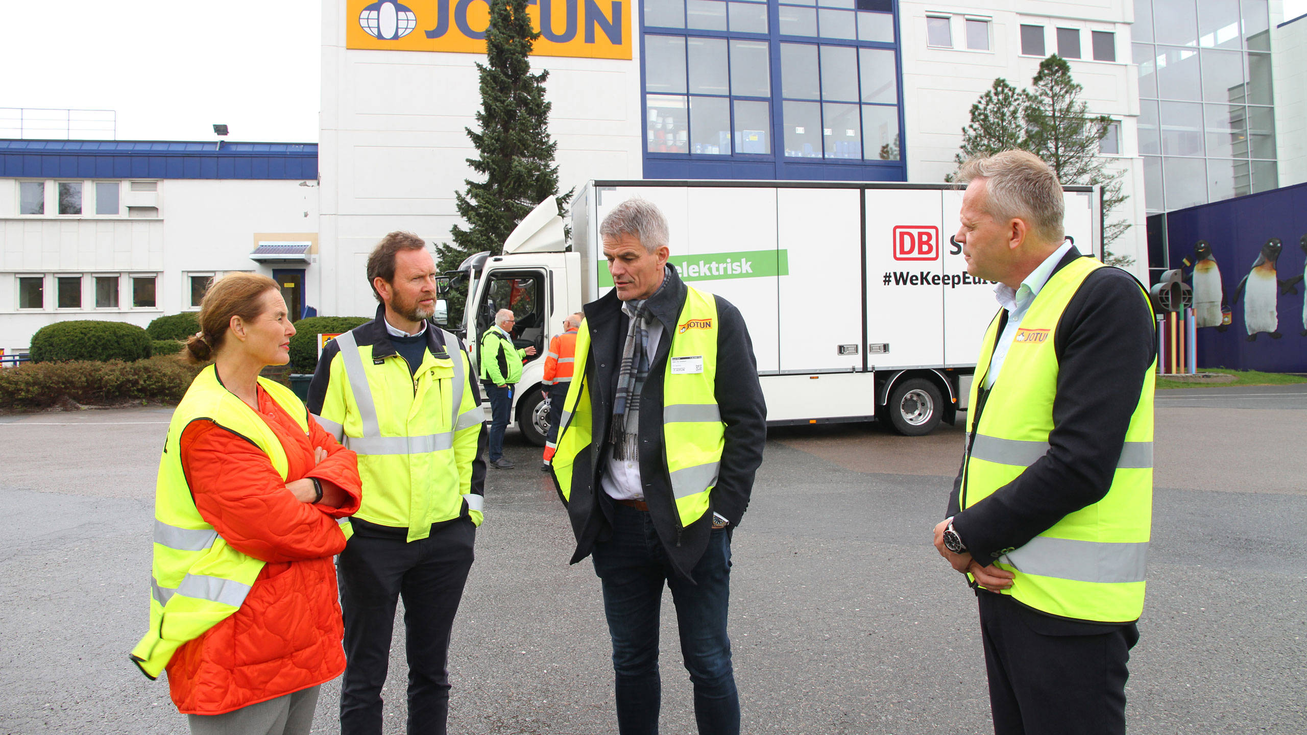 Four people outside the Vindal factory