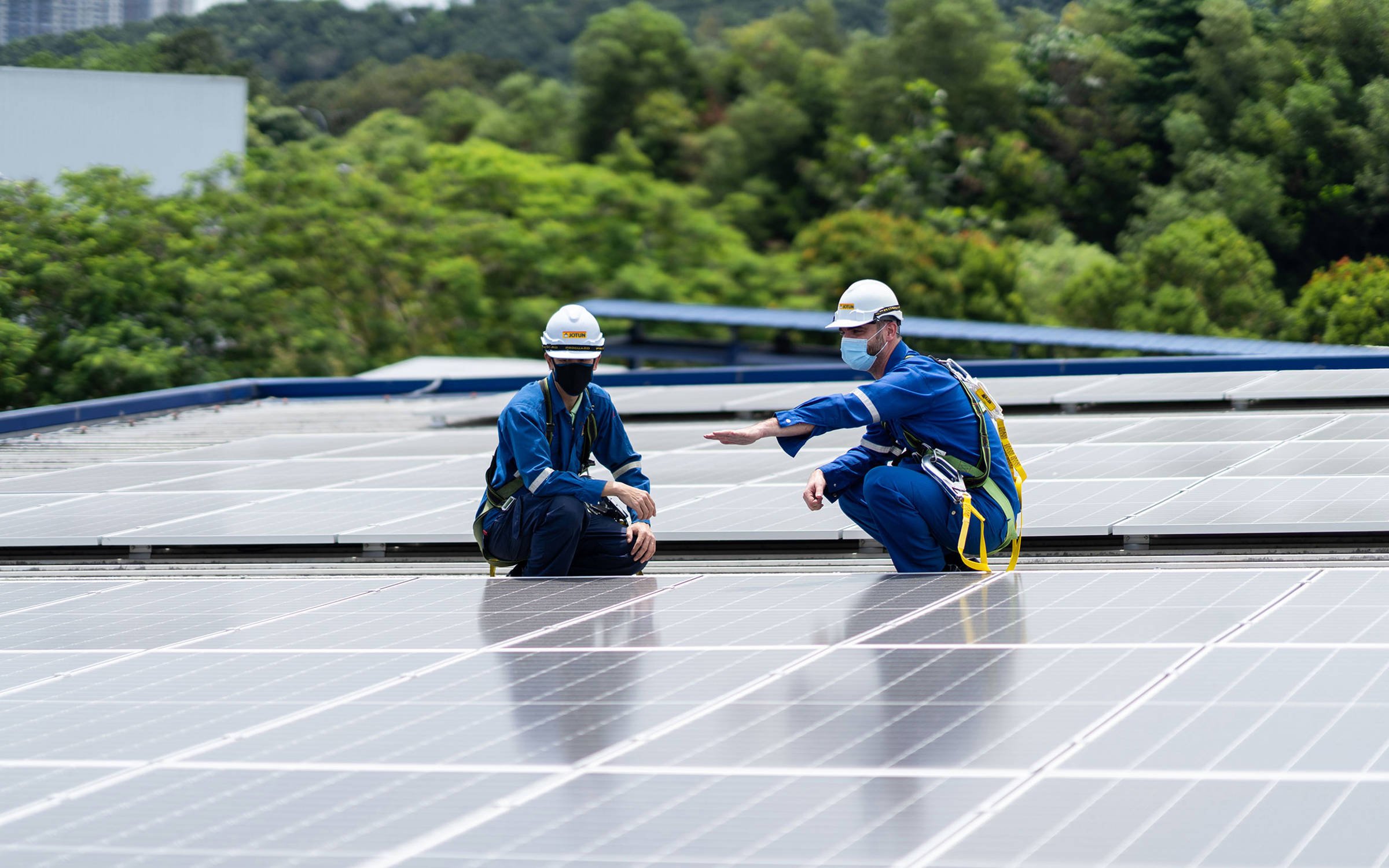 Jotun employees inspecting the solar panels that powers the Nilai factory in Malaysia.